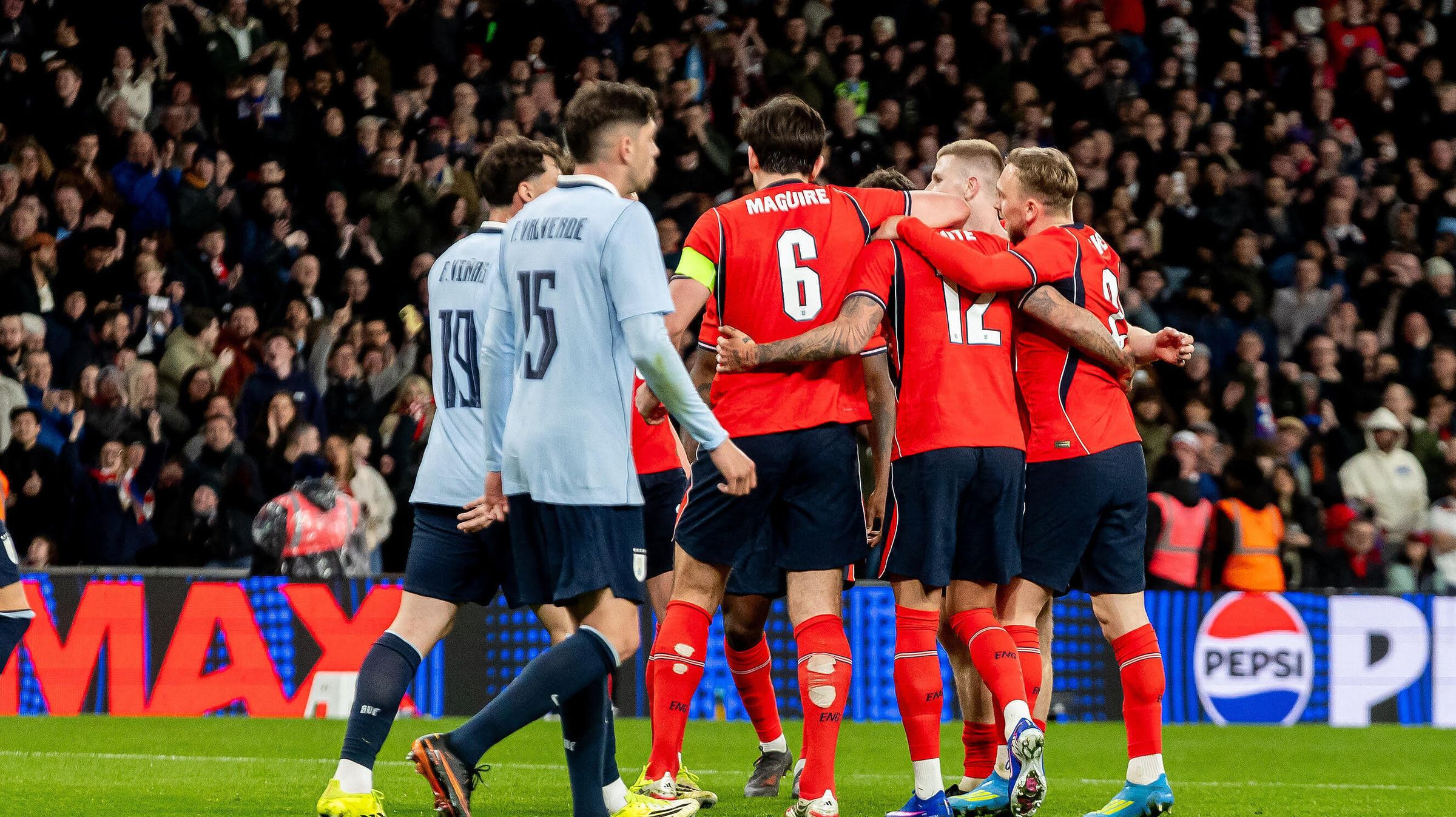 Ben White is congratulated by his England teammates after opening the scoring against Uruguay